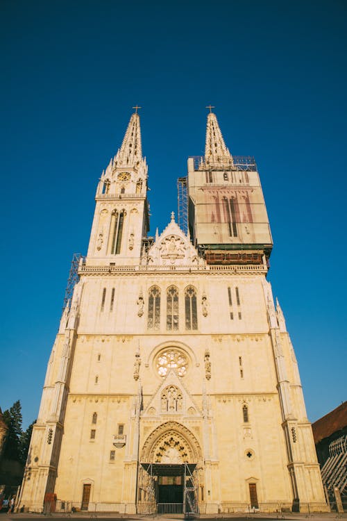 Low Angle Shot of a Gothic Church Facade against Blue Sky