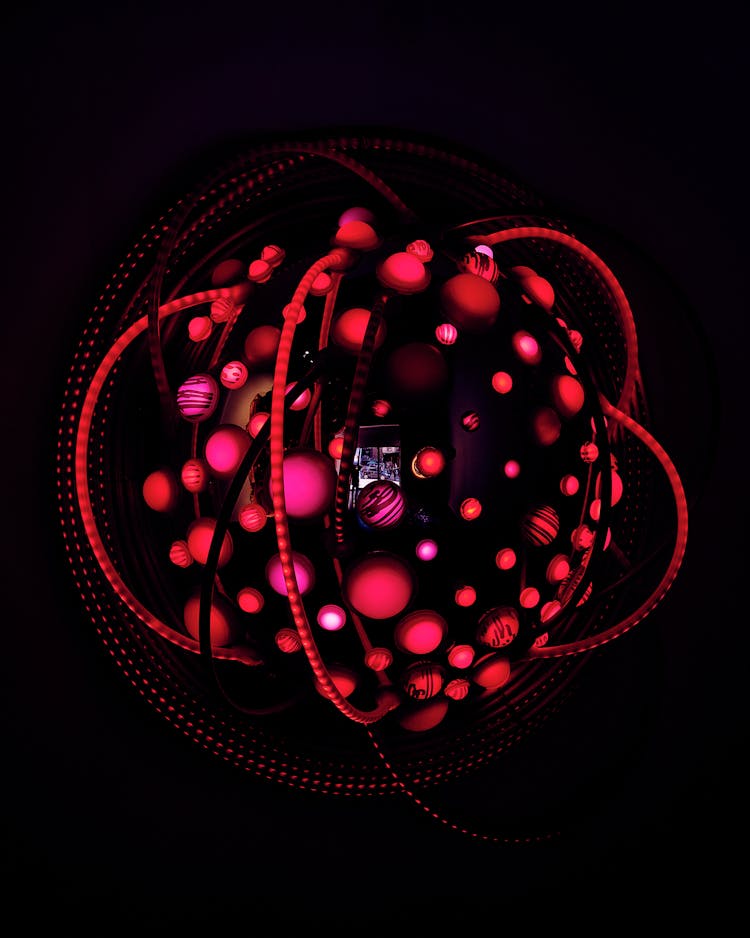 A Red Lighted Object On Dark Background