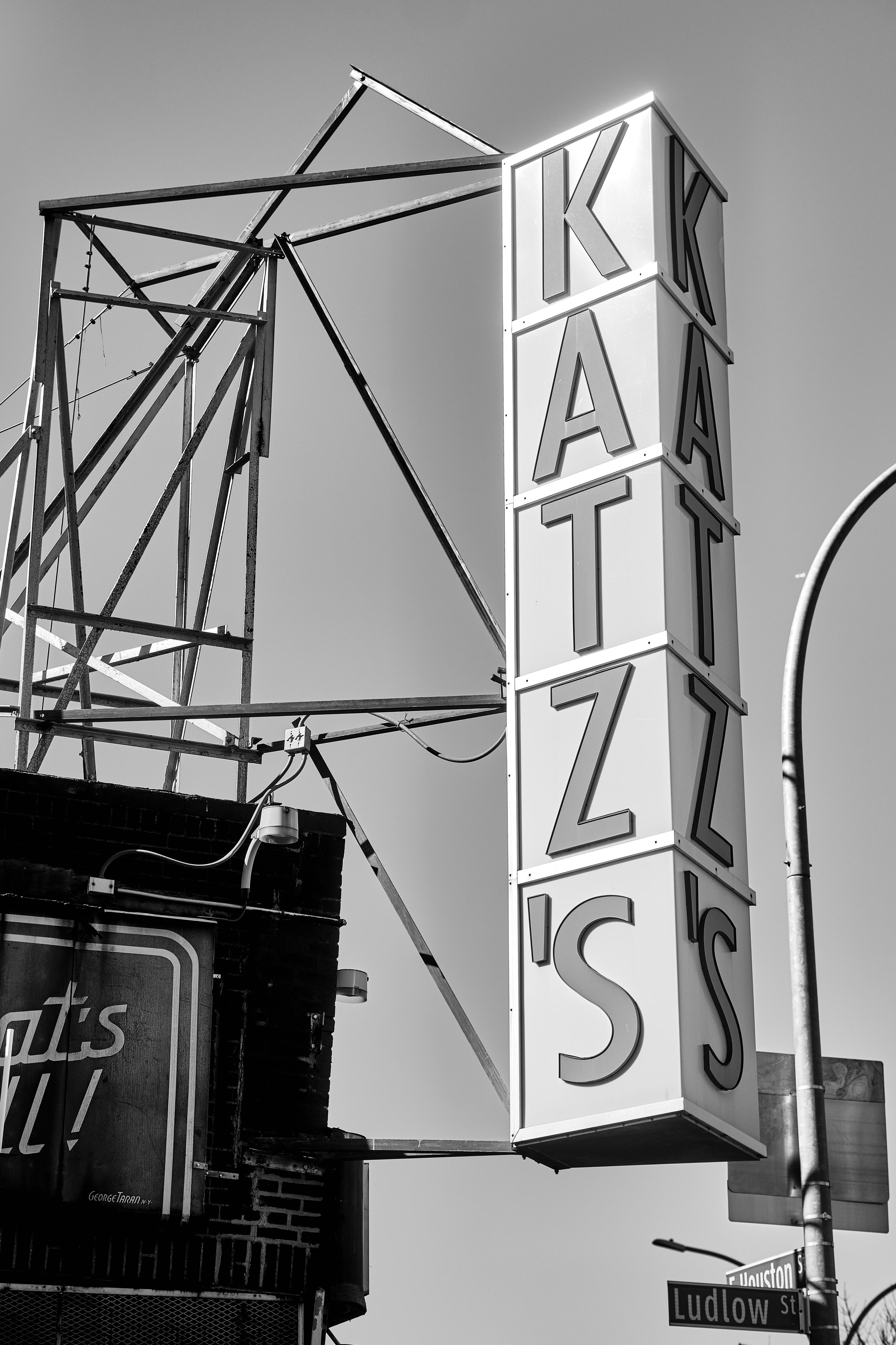 Photograph of Katz's Delicatessen sign in New York City, black and white style capturing the vintage essence.