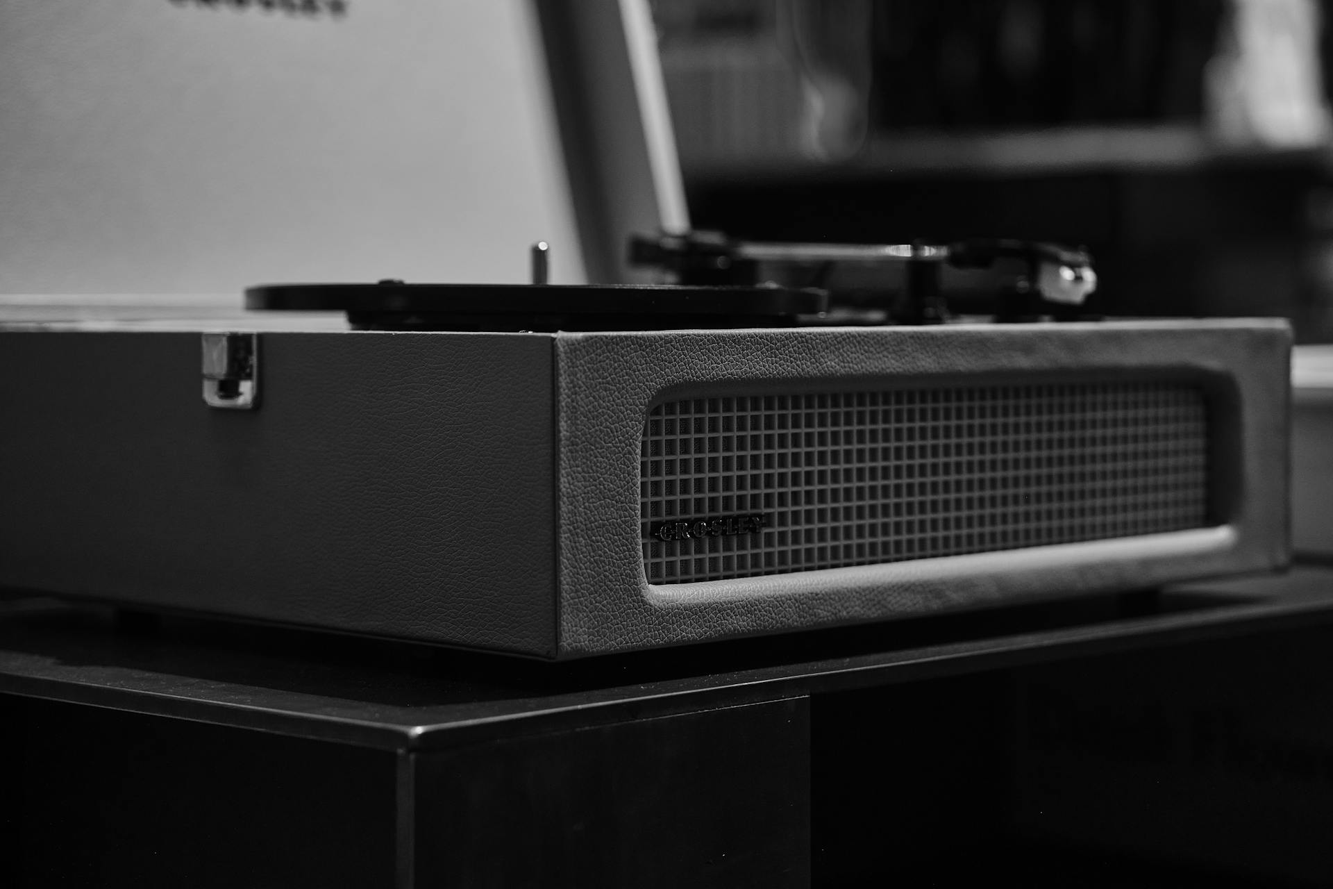 Black-and-white close-up of a classic vinyl record player in monochrome tones.