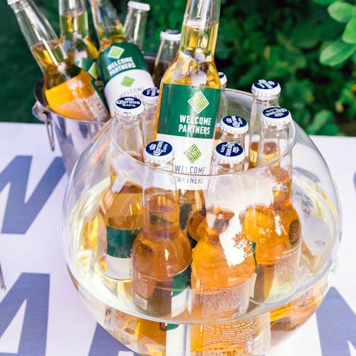 Close-Up Photography of Beer Bottles on Fishbowl