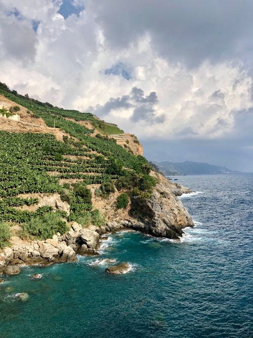 Free Majestic view of Antalya's rocky cliffs meeting the azure sea under a partly cloudy sky. Stock Photo