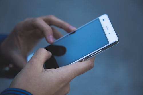 Person Holding White Smartphone