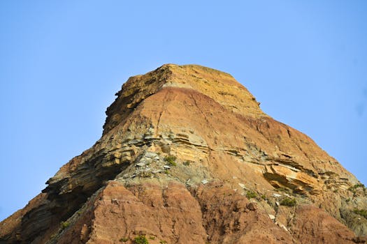 Beautiful layered rock formation under a clear sky in Peniche, Portugal.