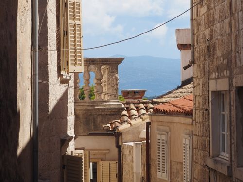 Free Charming stone architecture and rustic rooftops in a quaint Korčula alley. Stock Photo