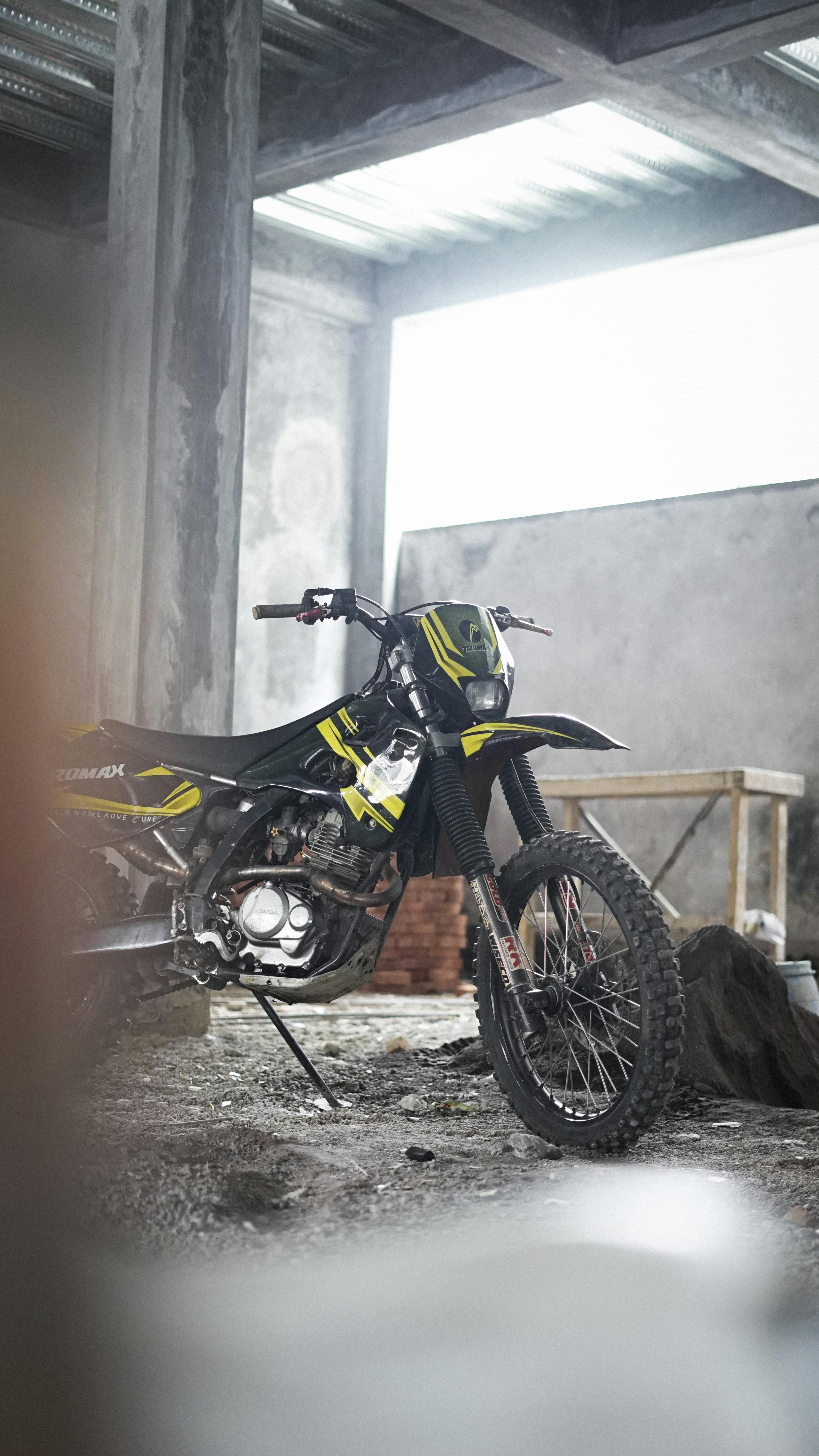 black motorcycle parked beside a column