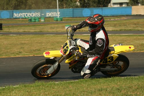 Racer Driving a Motorcycle on a Race Track