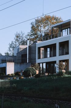 Contemporary facade of a suburban house surrounded by greenery, offering tranquility.