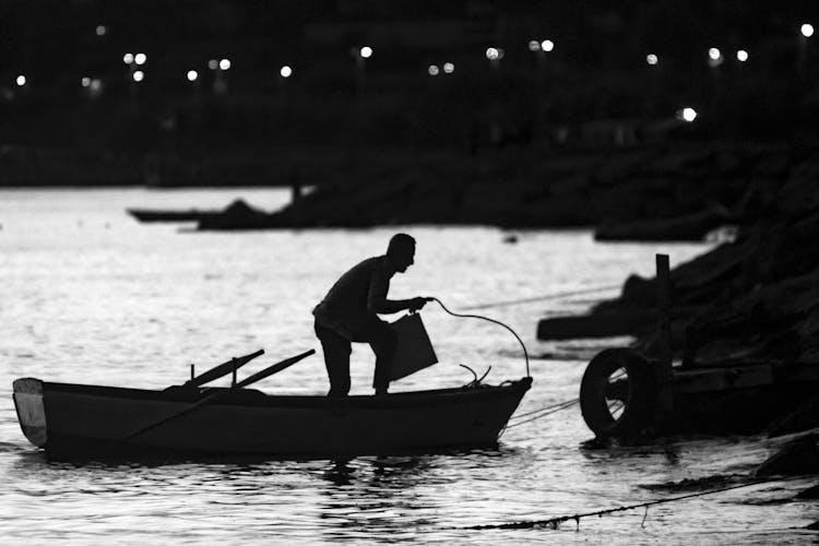 Silhouette Of A Man On A Rowboat