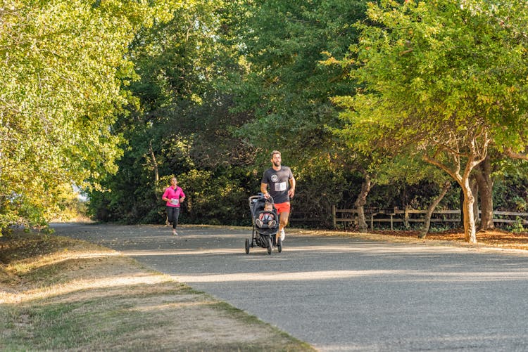 Man And Woman Jogging On The Road