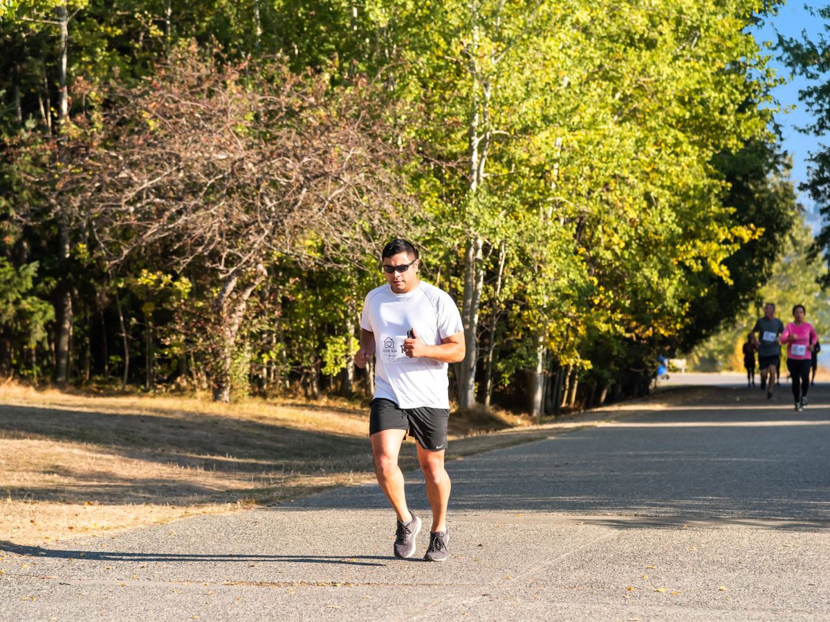 A runner on a tree-lined road