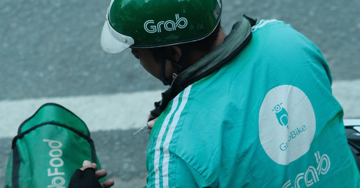 Grab Food Delivery Rider With Helmet · Free Stock Photo