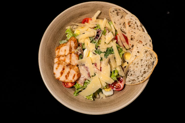 Salad In Bowl On Black Background