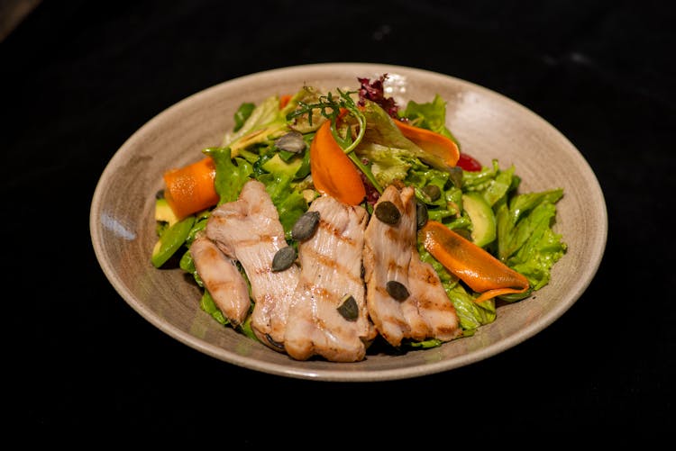 Grilled Meat On Top Of Vegetable Salad