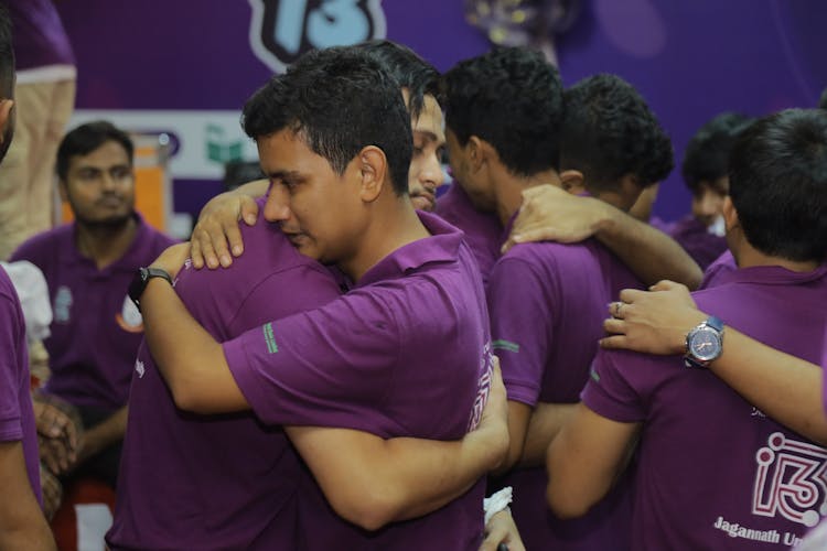 Men In Uniforms Hugging At Competition