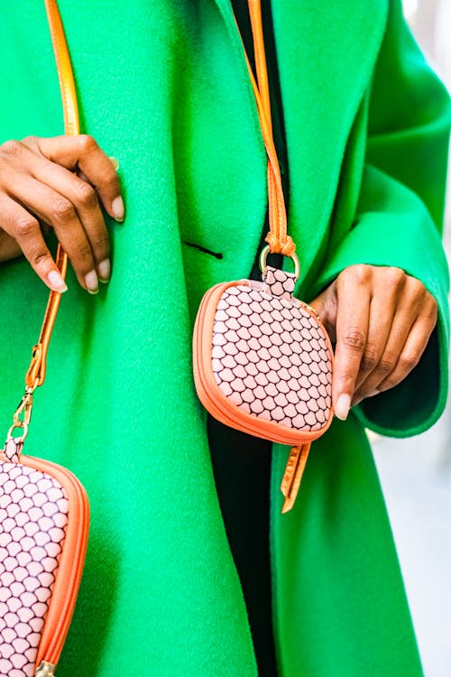 Woman in a Green Coat with a Handbag and a Purse 