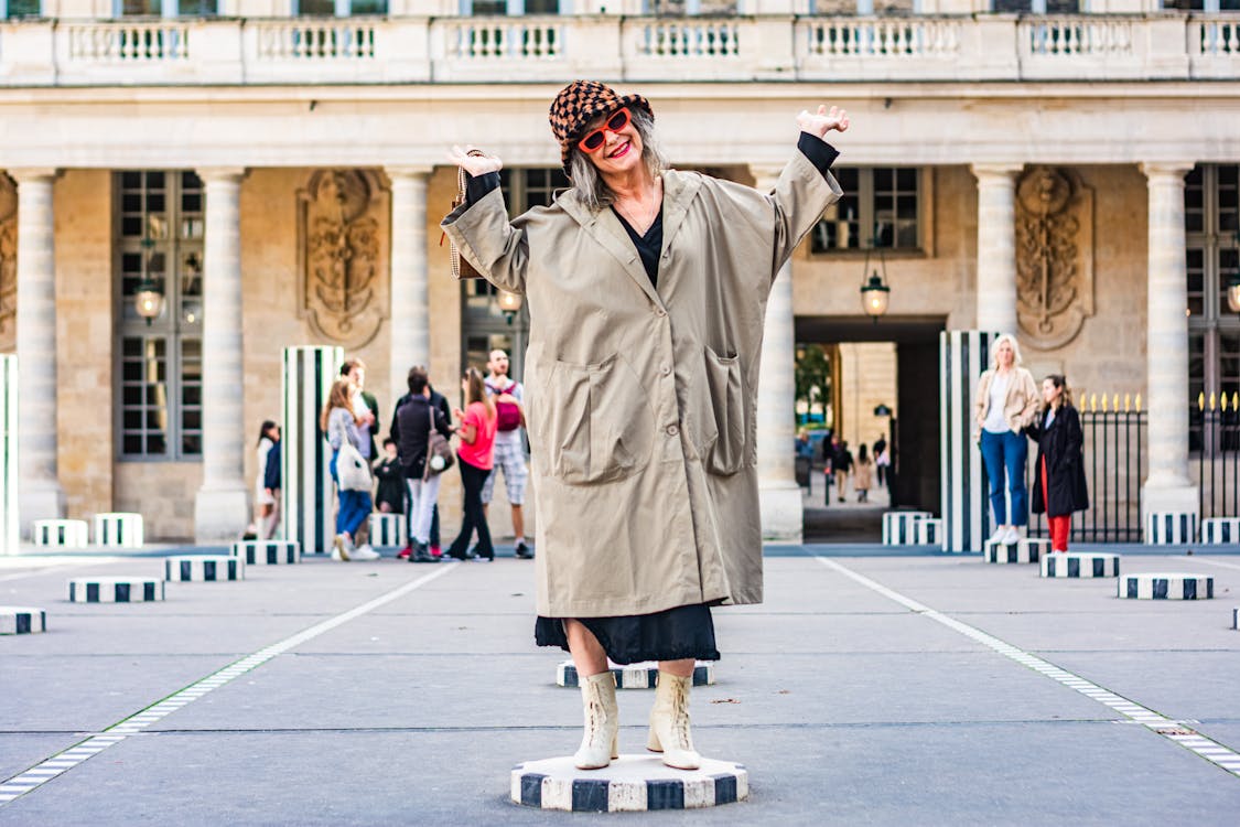 A Woman Wearing Sunglasses and Long Coat 