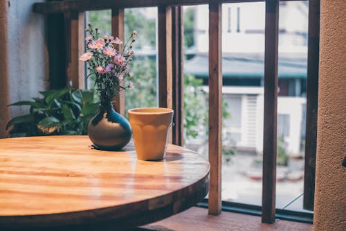 Free A Ceramic Cup and Potted Plant on a Wooden Table Stock Photo