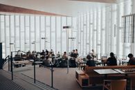 Spacious interior of Oslo public library with people reading and studying.