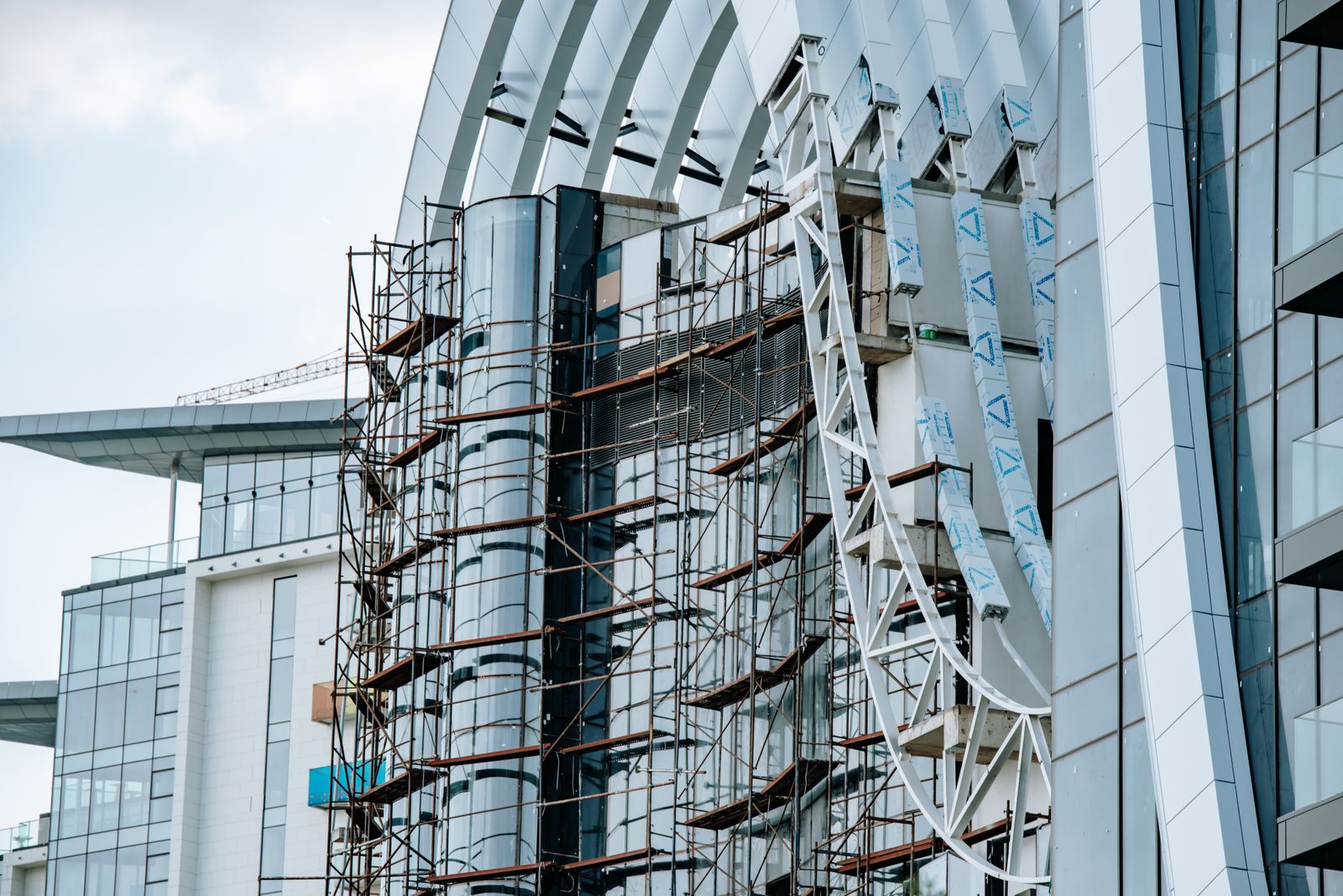 Modern high-rise building under redevelopment with scaffolding