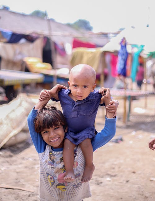 Kid Carrying a Toddler