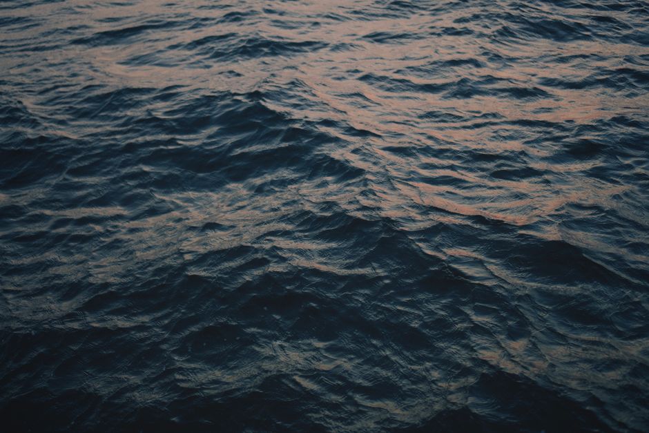 Close-up of serene sea waves under a warm sunset glow in Zadar, Croatia.