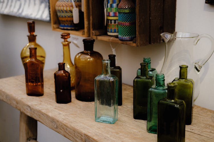 Empty Glass Bottles On A Wooden Table