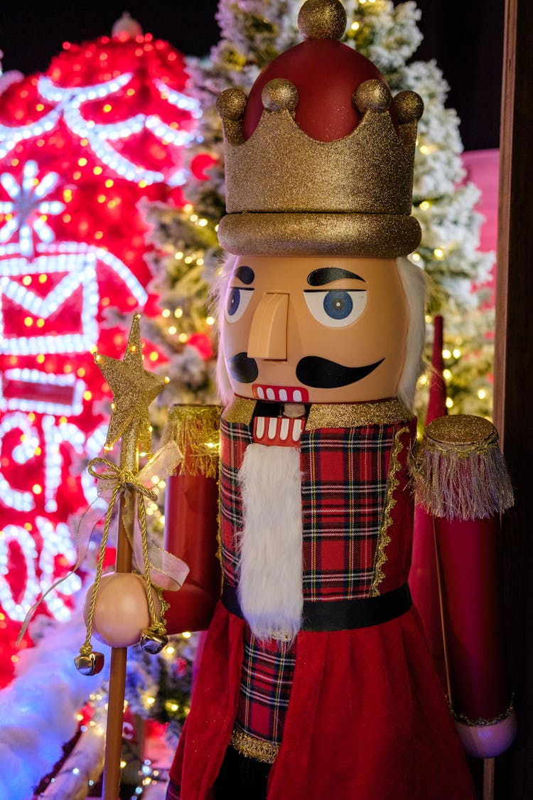 Nutcracker Figurine Beside A Christmas Tree