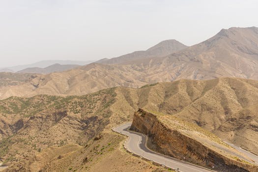 Winding road traversing the rugged Atlas Mountains in Marrakech, Morocco.