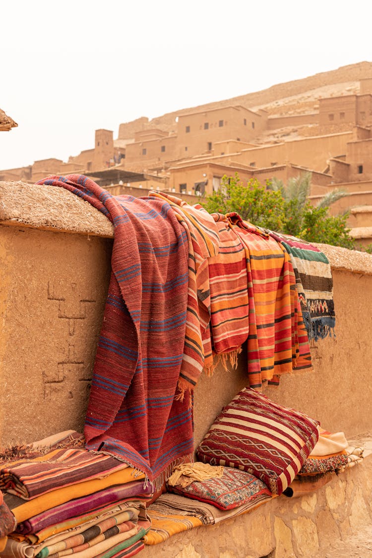 Colorful Floor Mats Under Stone Wall