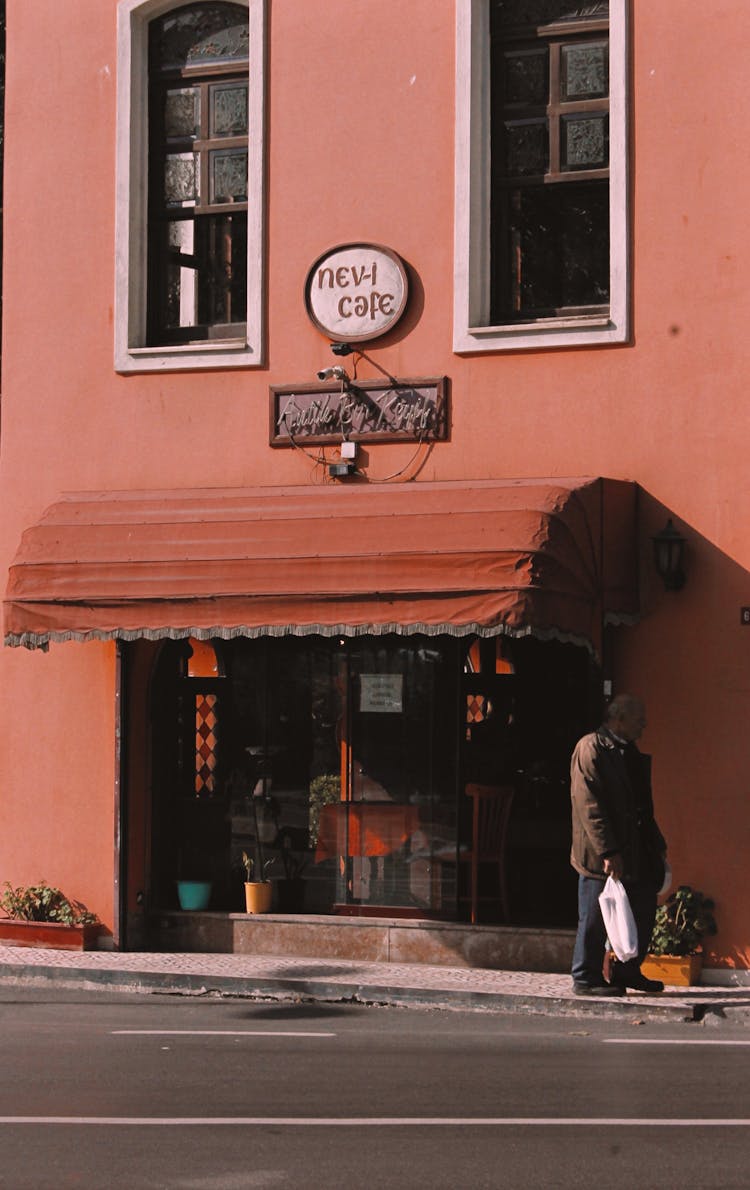 Man Standing Beside A Coffee Shop