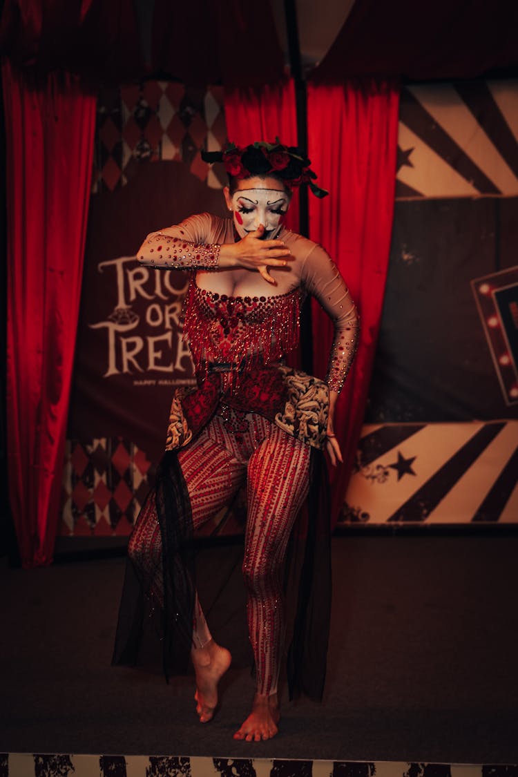 A Woman In Halloween Costume Dancing On The Stage