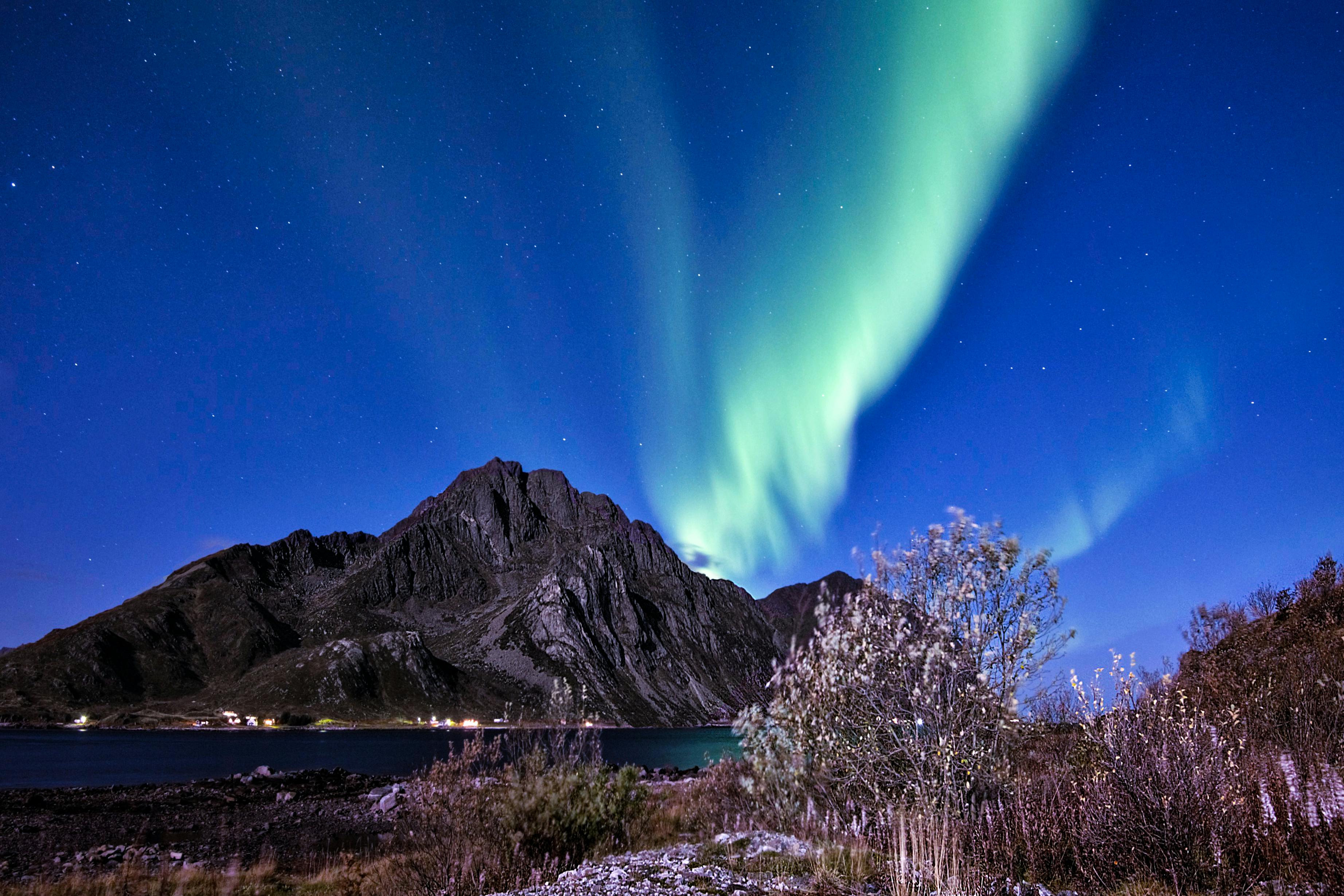 northern lights on sky above mt stornappstinden in lofoten