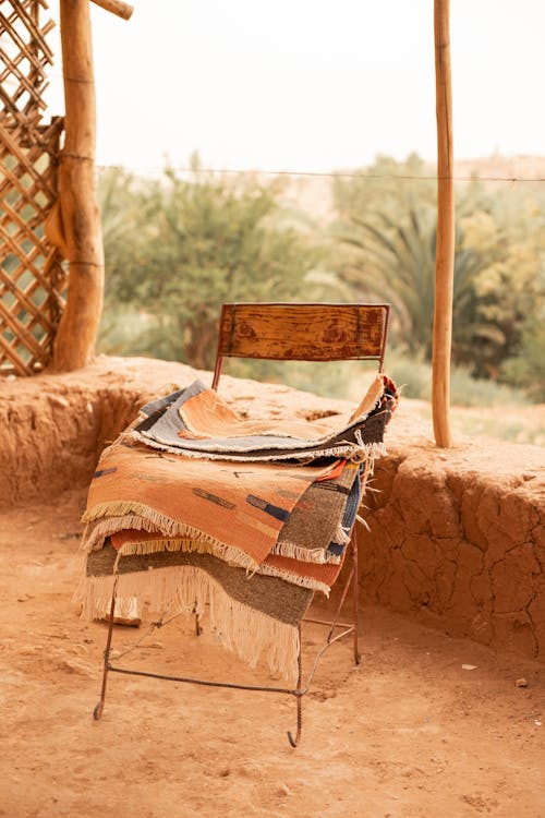 A Pile of Rugs on a Chair