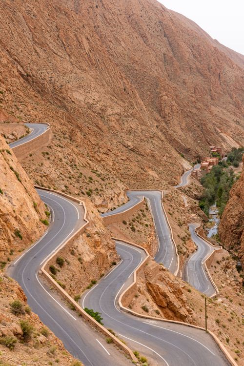 Free Stunning view of a winding road through arid mountain terrain, perfect for travel inspiration. Stock Photo