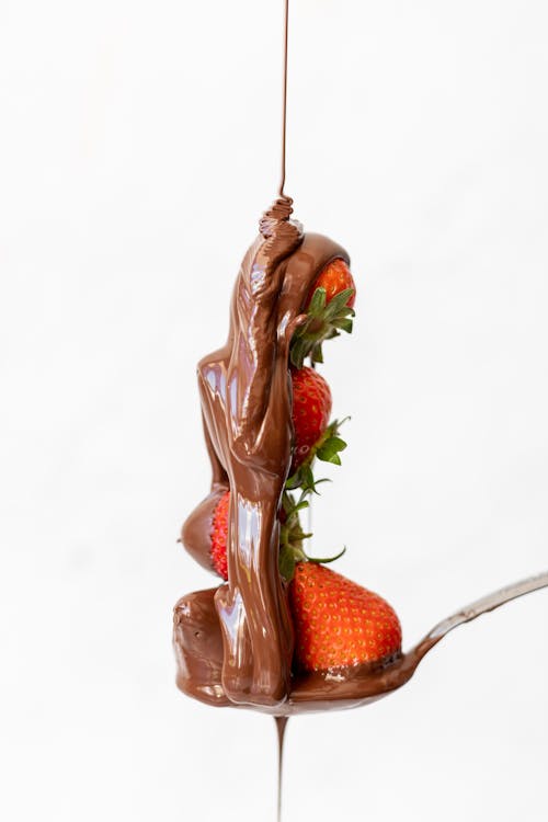Studio Shoot of Strawberries and a Chocolate Sauce against White Background