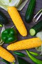 Three Yellow Corn Cobs, Bell Pepper, Cucumbers and Chili Peppers