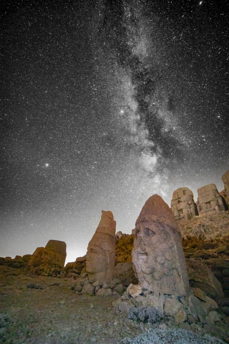 Stone Statues Under Milky Way