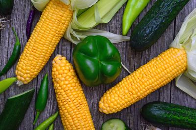 Corn, peppers and cucumbers on a wooden table — photo by Adonyi Gábor on Pexels
