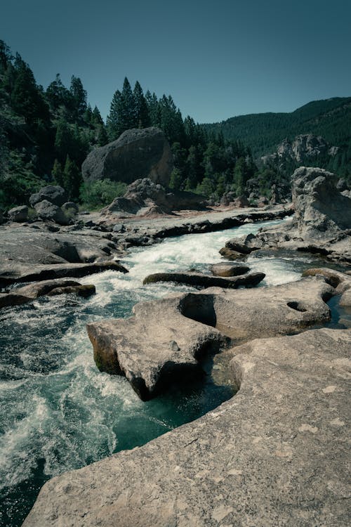 River Flowing on Rocks in Mountains Landscape