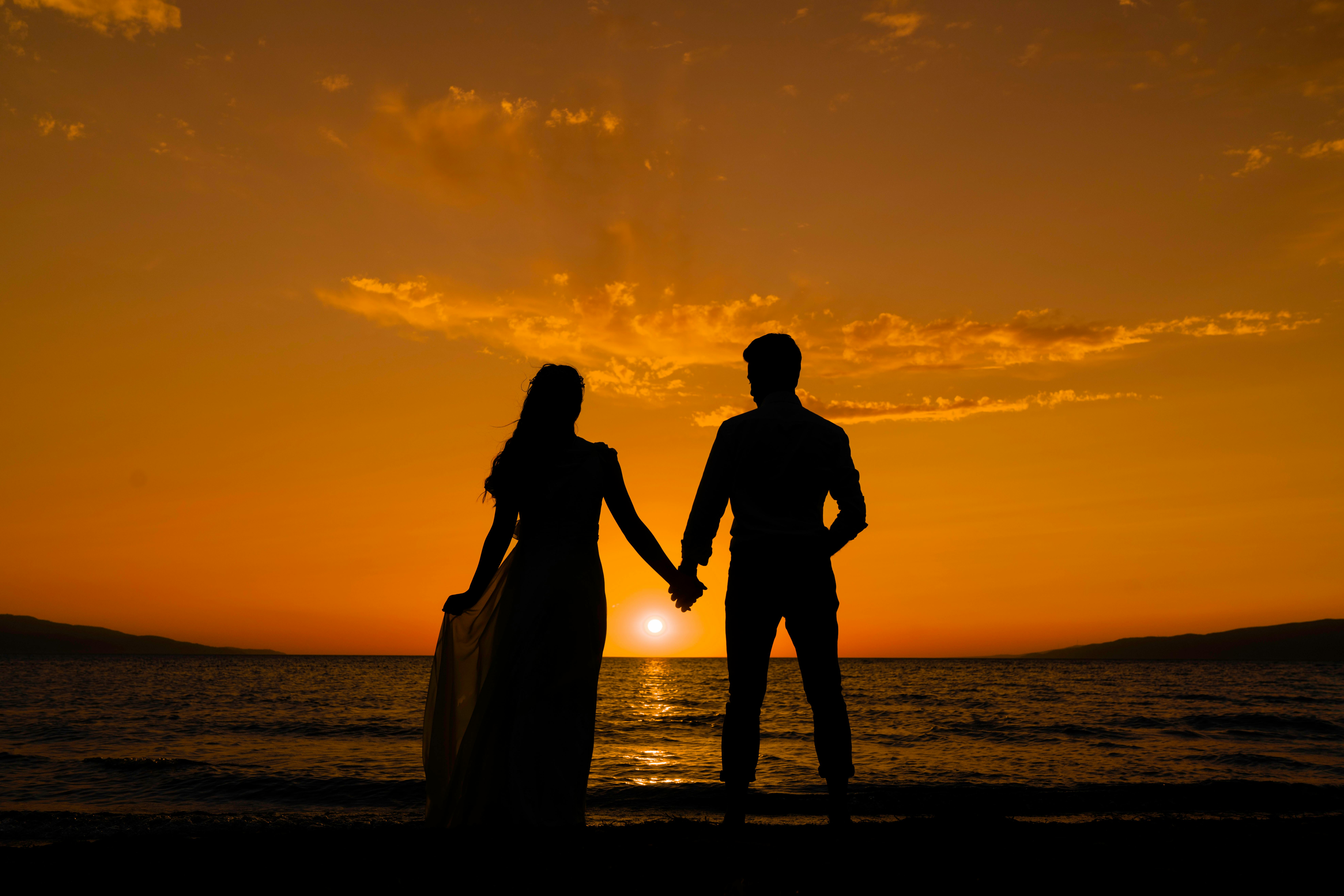 couple holding hands silhouette