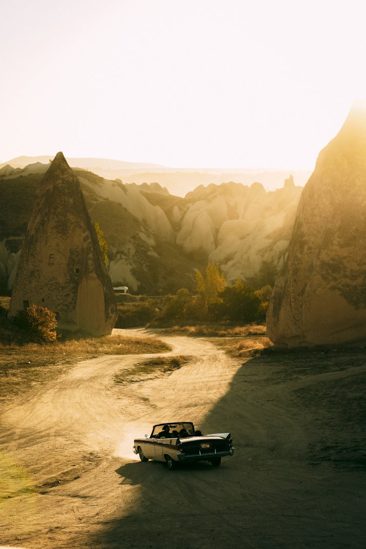 Retro Car In Desert In Mountain Landscape