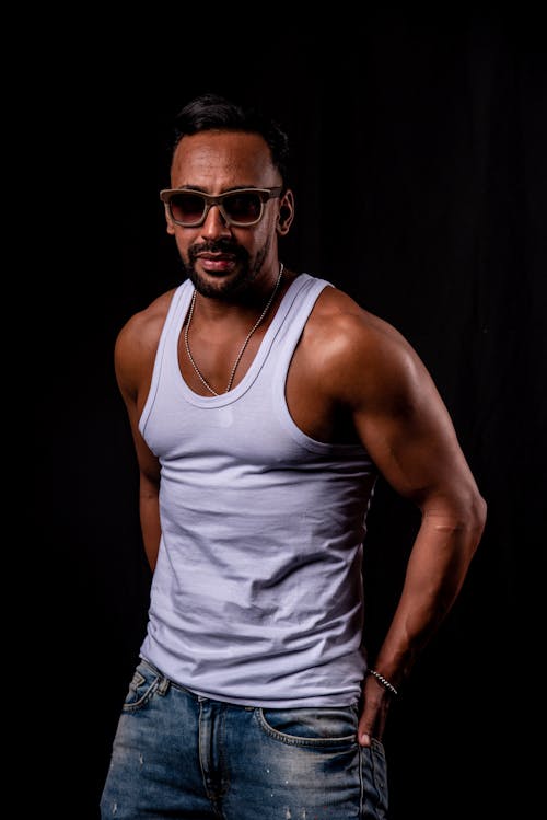 A Man in White Tank Top Wearing Sunglasses