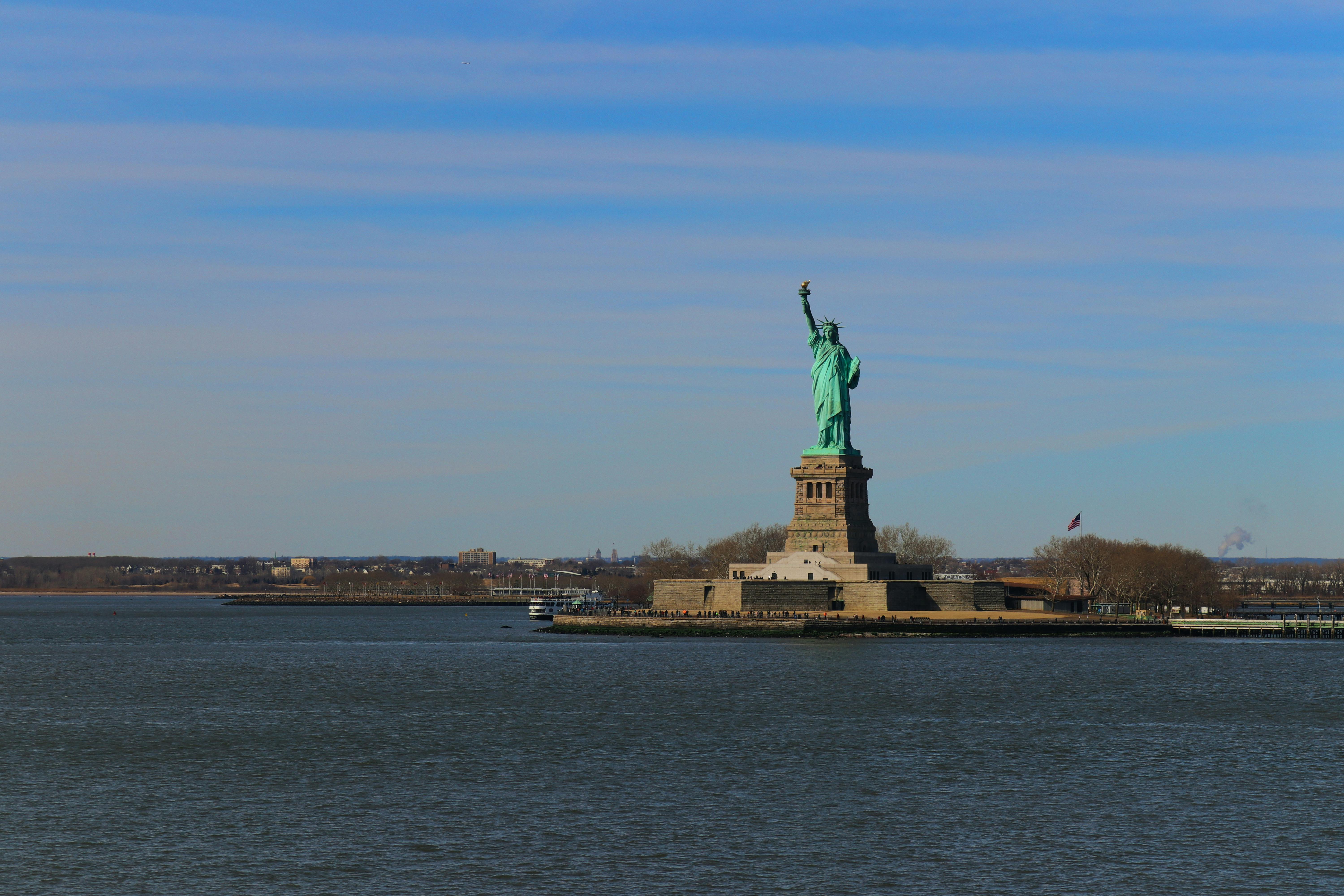 A Statue of Liberty Near the Body of Water · Free Stock Photo