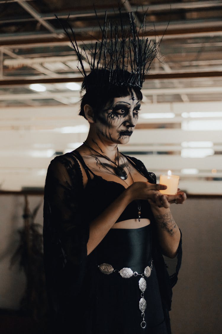 Woman In Halloween Makeup Holding Candle