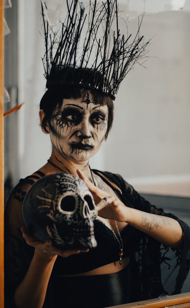 Woman In Halloween Costume Holding Skull