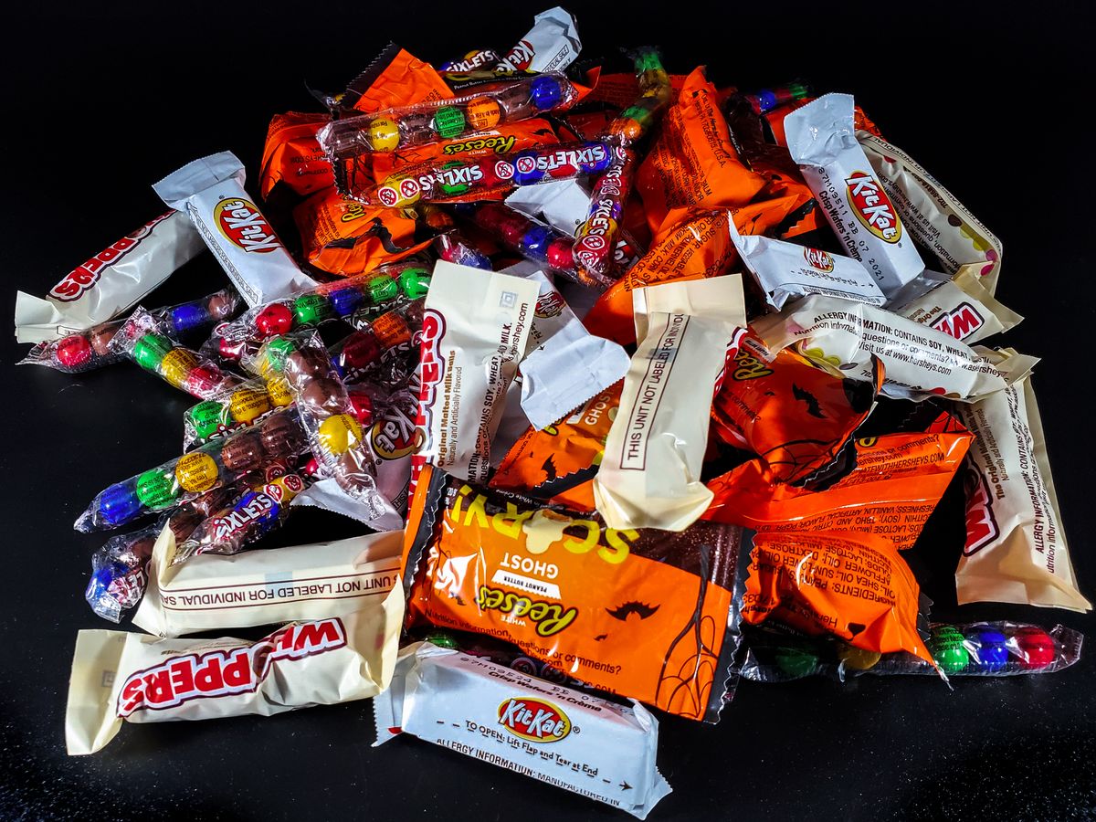 Pile of assorted Halloween candies and full-size chocolate bars for VIP goodie bags