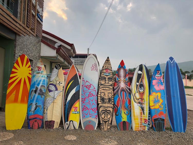 Lined Up Surfboards Beside A House