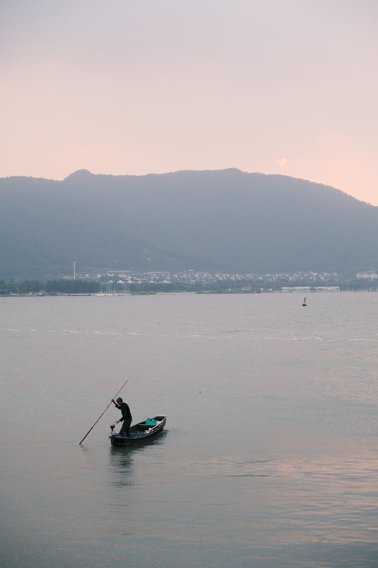 A Person Riding A Boat On The Sea