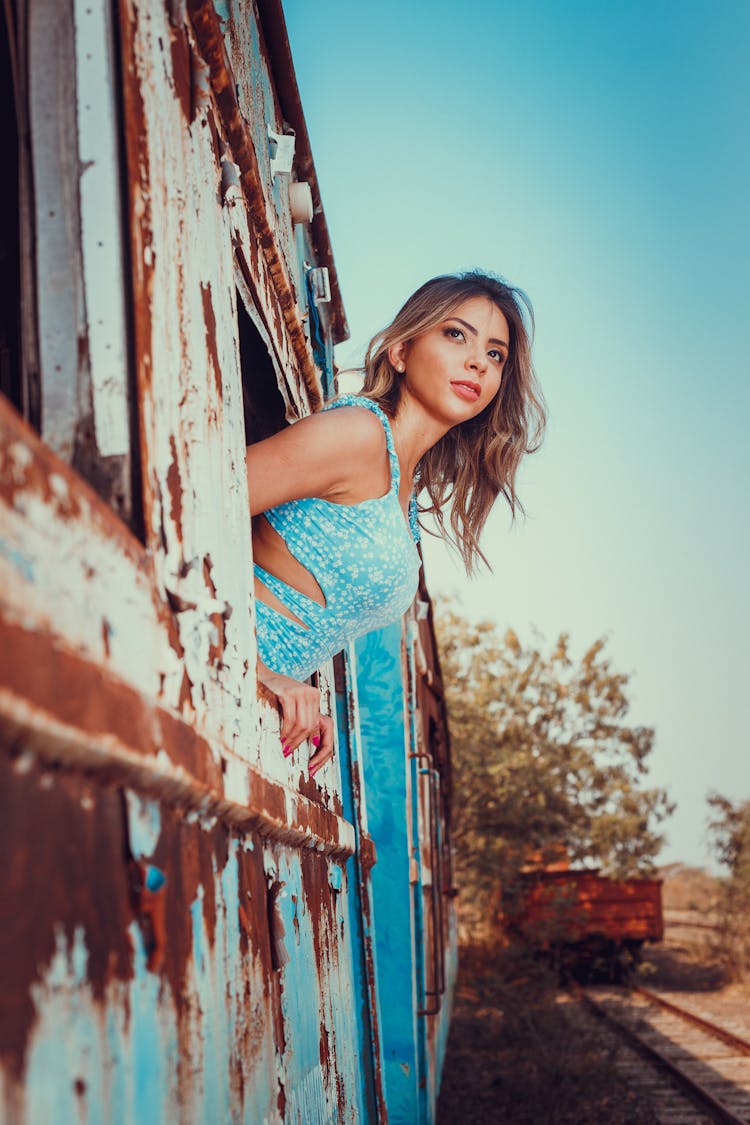 A Woman In Blue Tank Top Inside The Train